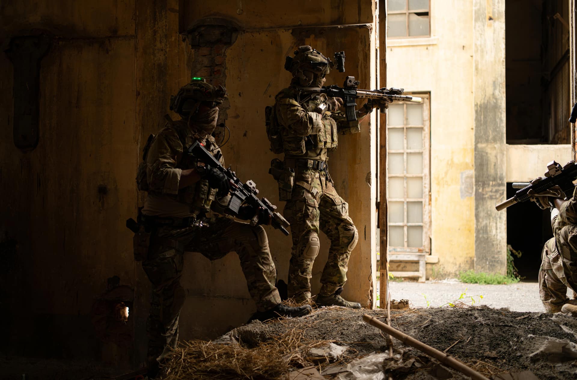 Team stacked in a doorway aiming into a building